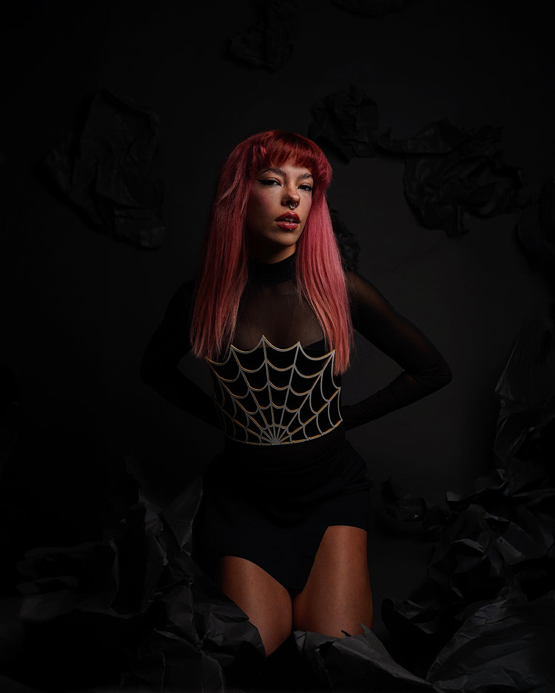 model wearing a leather corset with a lasercut spiderweb detail