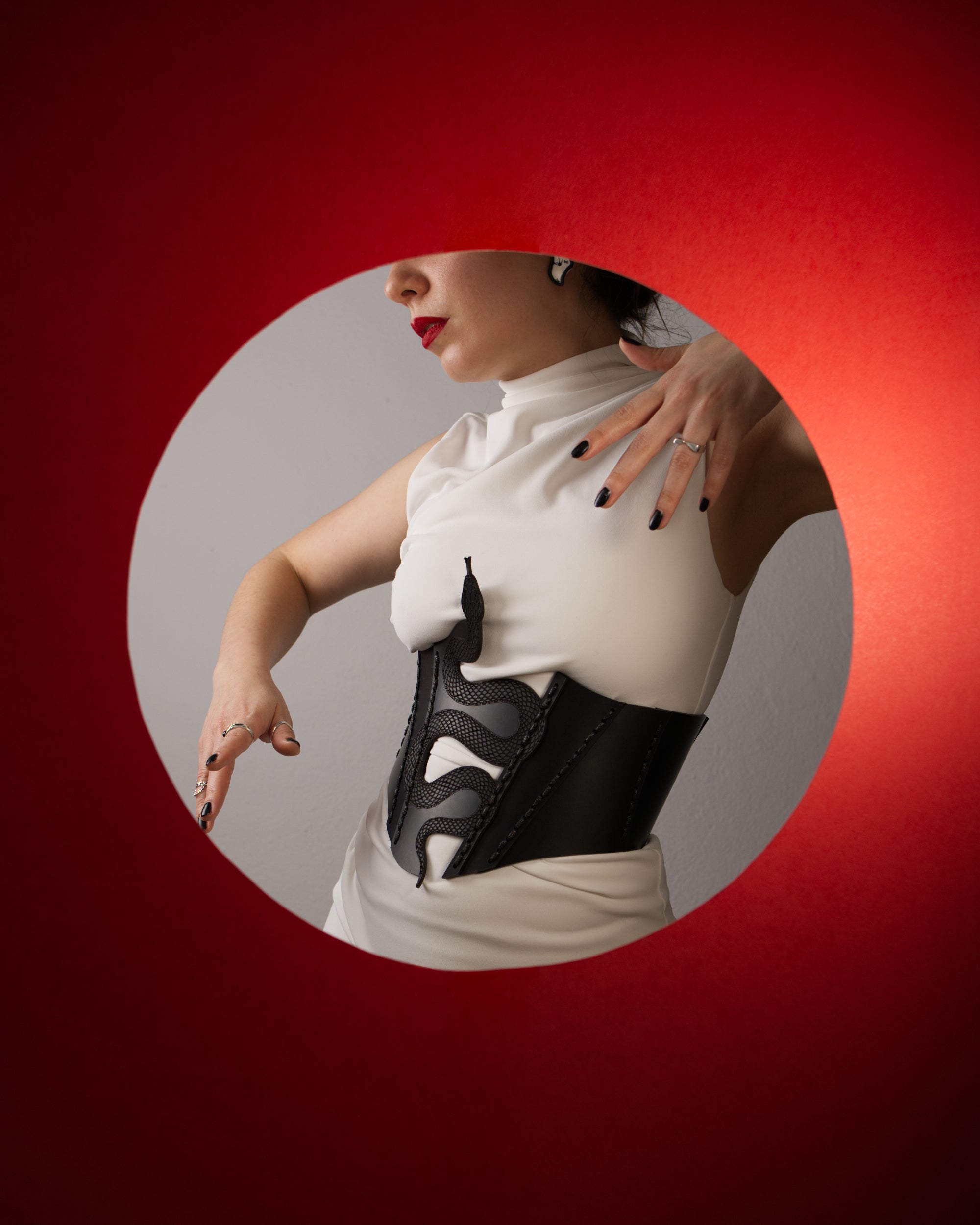 black leather underbust corset with lasercut snake design
