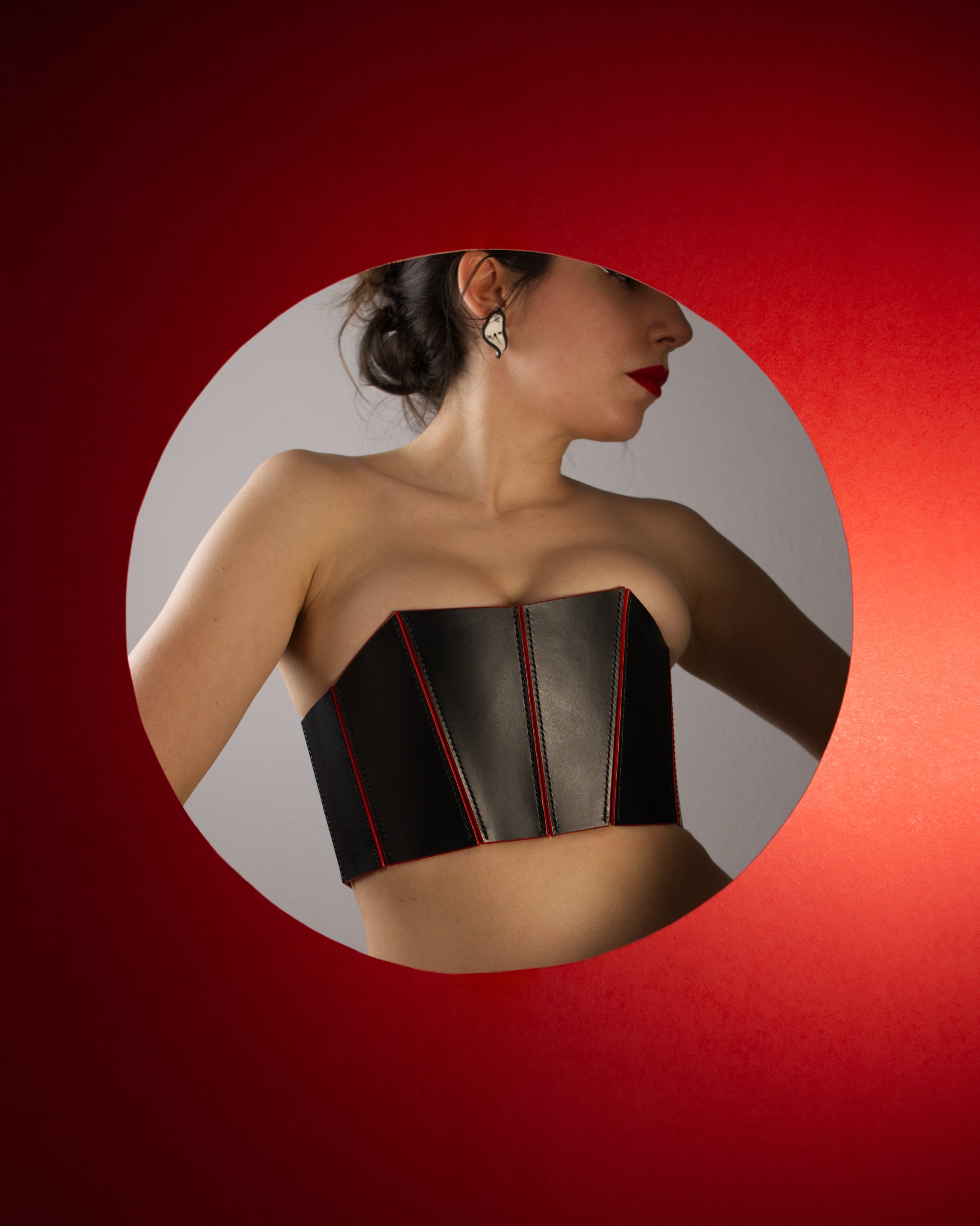 black handstitched leather corset with painted red edges