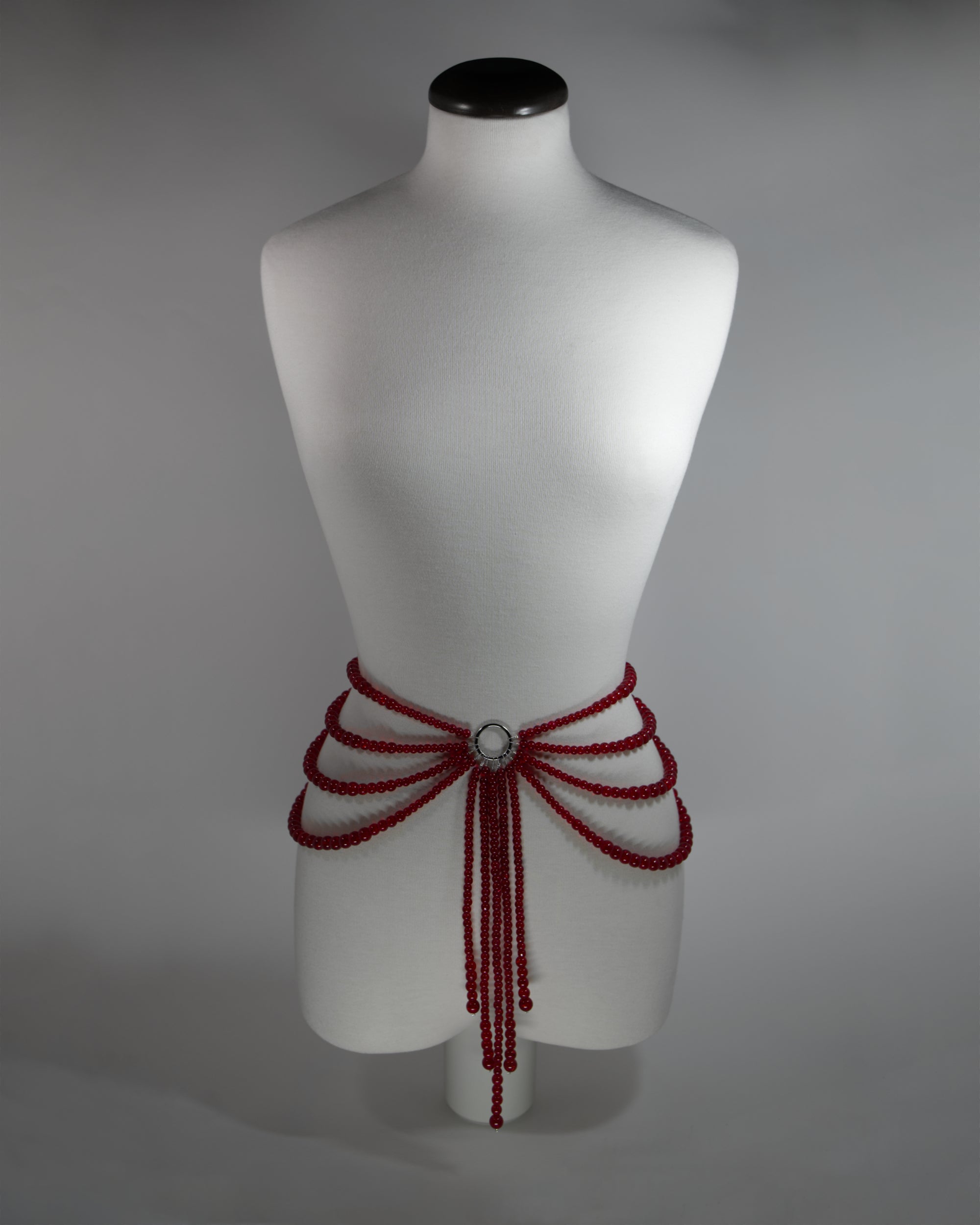 belt with red crackled glass beads and draping design on the hips inspired by persephone