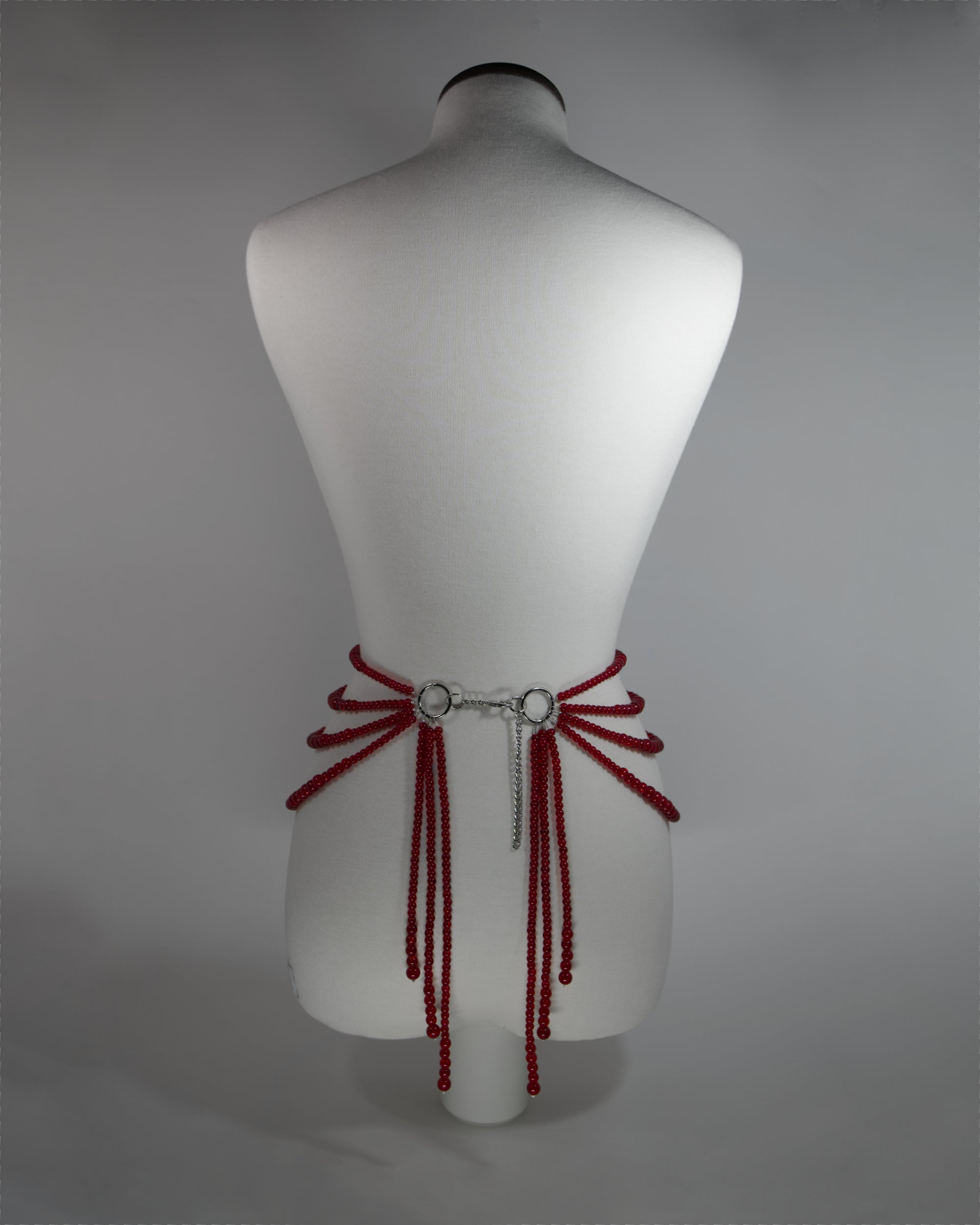 belt with red crackled glass beads and draping design on the hips inspired by persephone