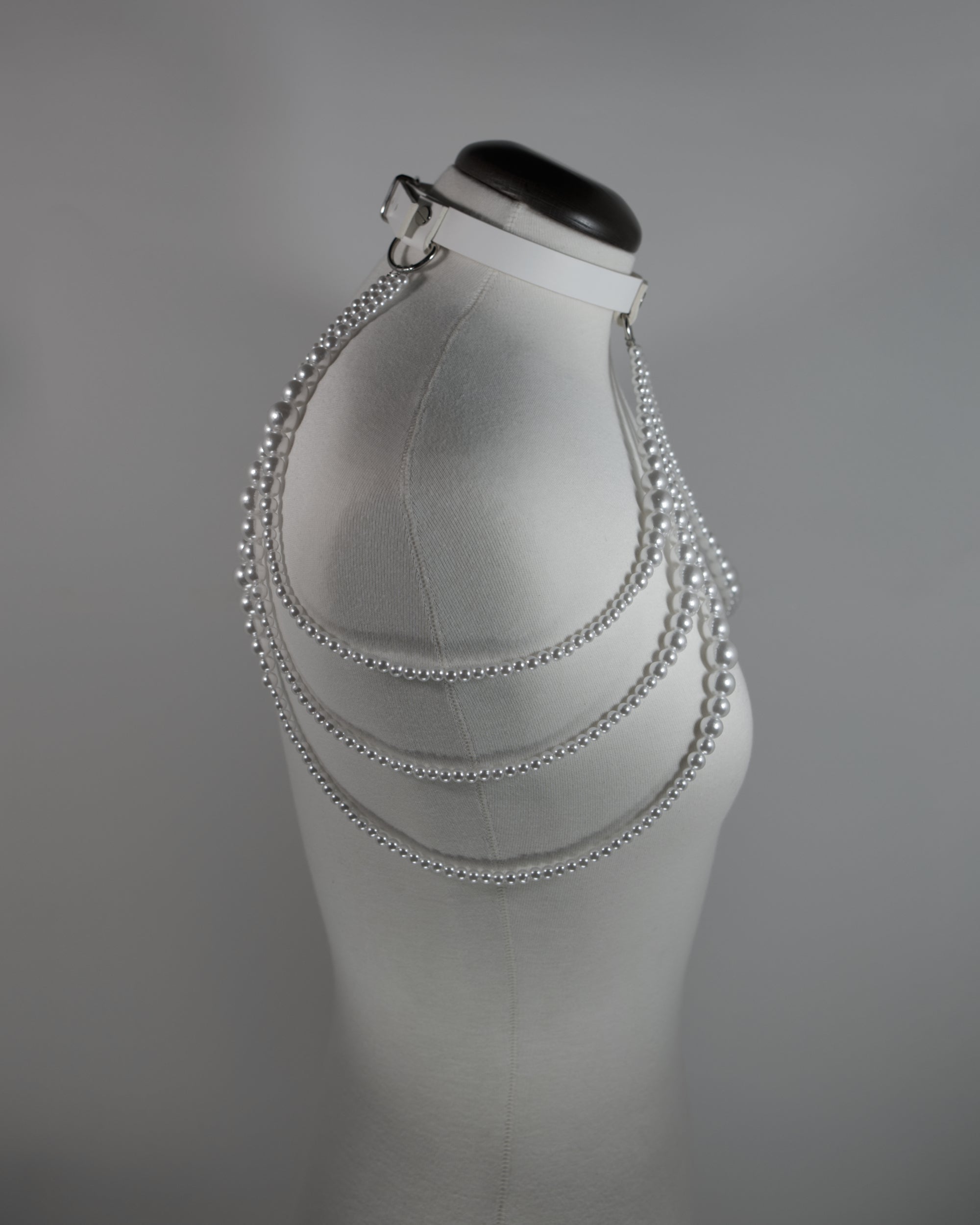 white leather choker with pearl straps draping on the shoulders