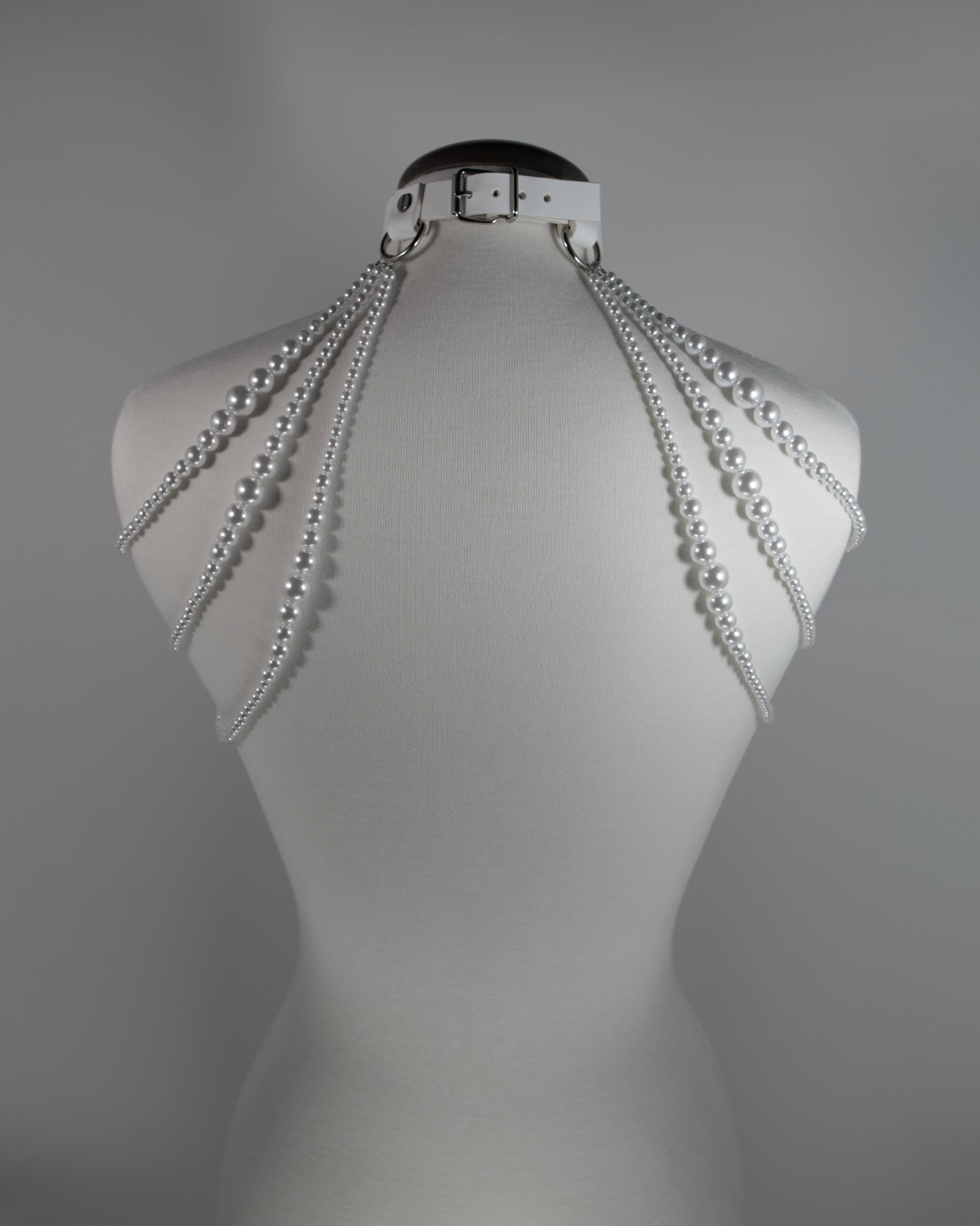 white leather choker with pearl straps draping on the shoulders