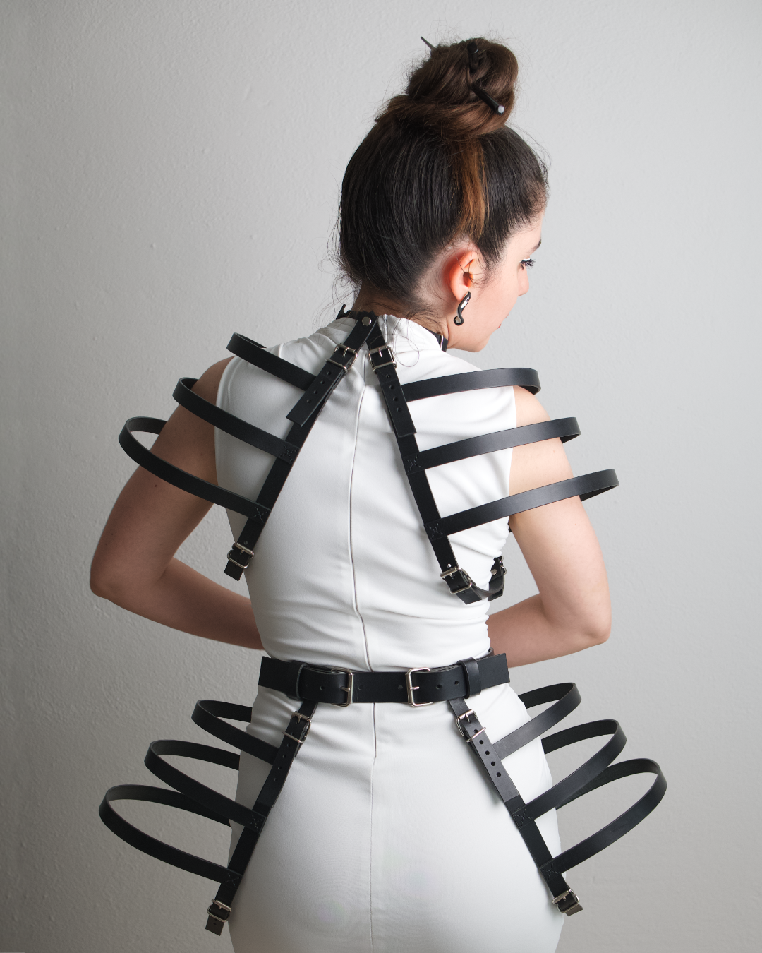 avant garde outfit with leather belt and leather choker harness