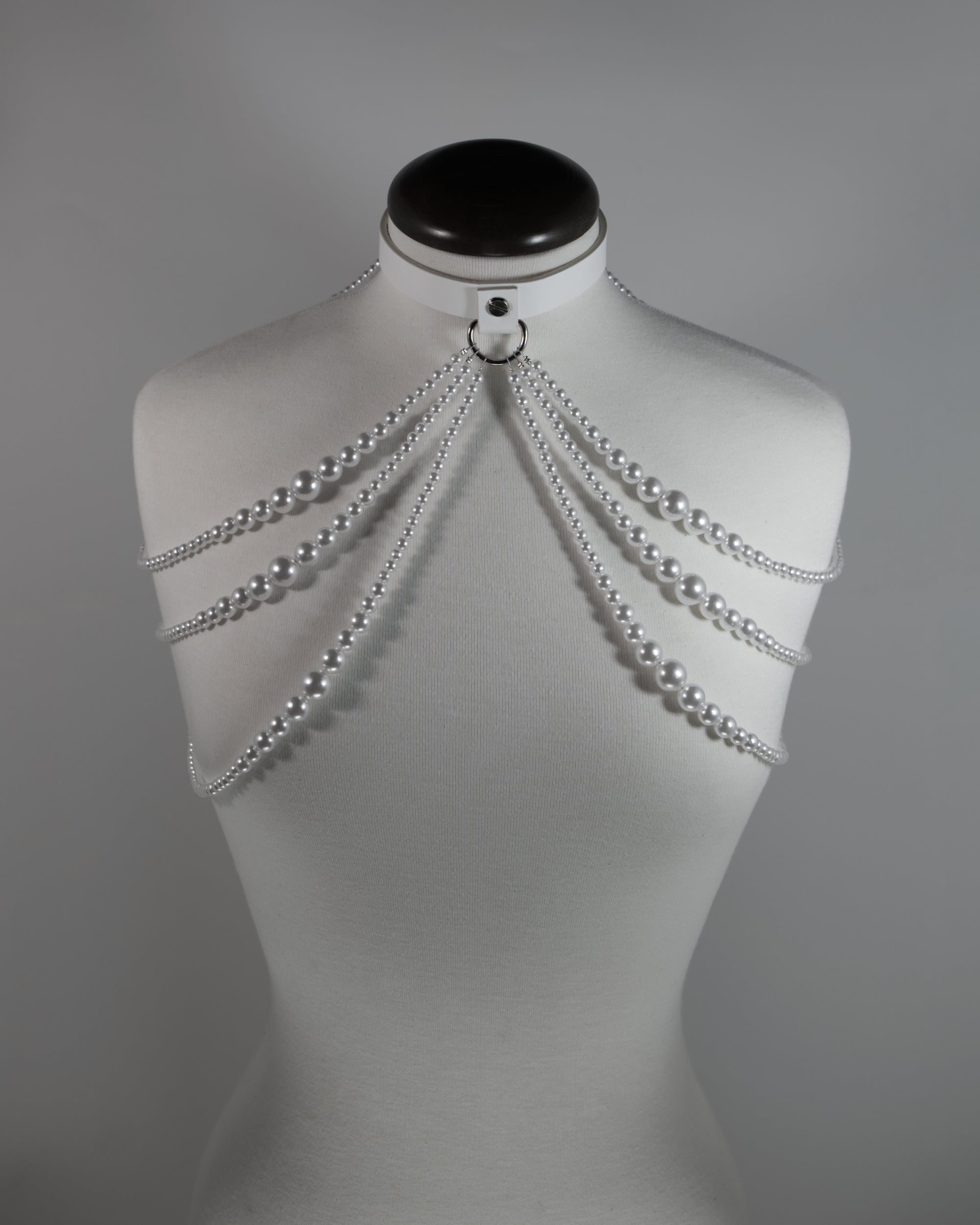 white leather choker with pearl straps draping on the shoulders